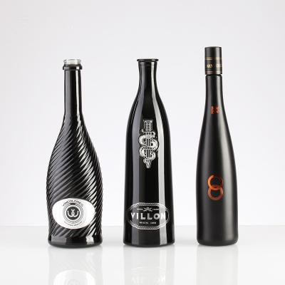 China Vodka whiskey glass bottle packaging factory supply custom design black embossed logo spray liquor bottle for 700ml 750ml vodka glass bottle for sale