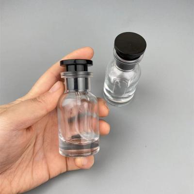 China 30ML Cosmetic Wholesale Cylindrical Perfume Spray Bottle Can Be Filled Empty Spray Bottle With Black Semicircular Cap for sale