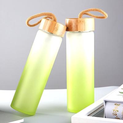 China 2020 Sustainable New Launch Color Spray Painted Bamboo Glass Water Bottle With String for sale