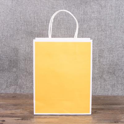 China Recyclable Wholesale Custom Printed Custom Logo Yellow Kraft Reusable Paper Shopping Bags With Handles for sale