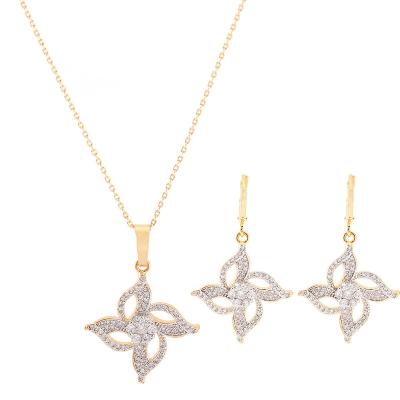 China Popular Wholesale Gold Plated Hyperbole Four Leaf Clover Metal Stud Necklace Earrings Gold Wedding Jewelry Set for sale