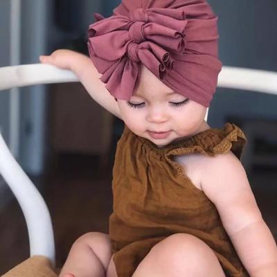 China Wholesale 100% Cotton Friendly Material Purple Color Folds Bow Indian Baby Knitted Hats Baby Winter Knotted Turban for sale