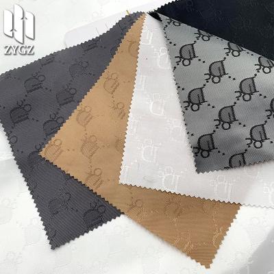 China Wind proof fashion brand double sided jacquard fabric satin jacquard clothing fabric luggage lining wholesale for sale