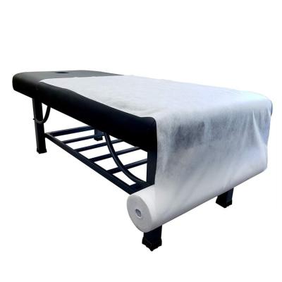 China Disposable Beauty Salon Disposable Bed Sheet Roll Cross Hole with Hole Waterproof and Oil-Proof Medical Massage Non-Woven Fabric for sale