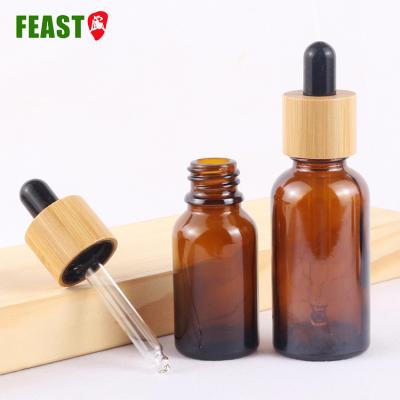 China Cosmetic Bottle 30ml 50ml 100ml Amber Oils Cosmetic Glass Essential Oil Bottle With Bamboo Lid for sale