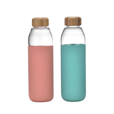 China Viable Portable Transparent Glass Drinking Water Bottle With Lid Borosilicate Glass Bamboo Water Bottle With Silicone Sleeve for sale