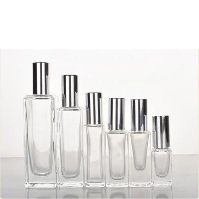 China Custom Refillable Fancy Size Glass Bottle Square Personal Care Essence Glass Perfume Bottles Travel With Metal Roll On for sale