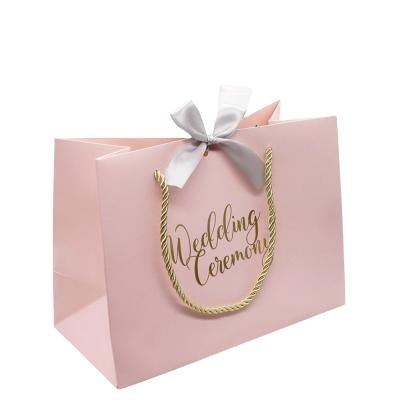 China 190GSM C1S Biodegradable Gift Paper Bag With Ribbon for sale