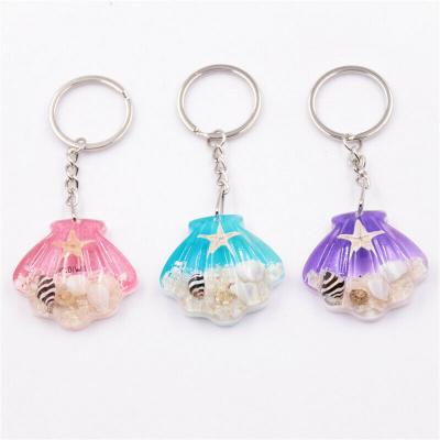 China Souvenir Gifts Promotion Cute Shell Shaped Starfish Specimen Key Chain Amber Luminous Resin Car Key Chains for sale