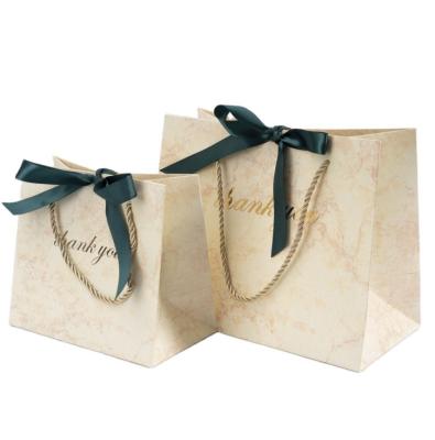 China Recyclable Marble Texture Bronzing Gift Bag Horizontal Version Card White Paper Bag With Hand Gift Thank You Bag for sale