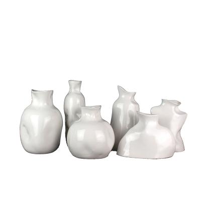 China Simply sells the modern luxury rough imitation irregular shape pottery white ceramic flower vase wholesale for sale