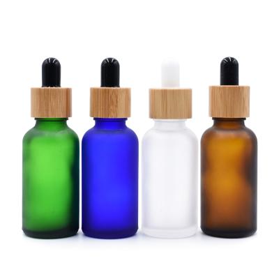 China 10ml 15ml 30ml Cosmetic Eco-Friendly Bamboo Dropper Frosted Glass Essential Oil Bottles Manufacturer for sale