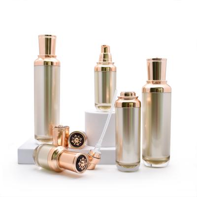 China Luxury Gold Cosmetic Luxury Gold Serum Lotion Pump Bottle 15ml 30ml 50ml 100ml Acrylic Plastic Cosmetic Packaging Set for sale