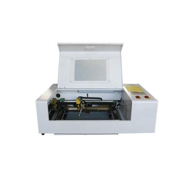 China 2022 Newest Small Water Cooled 3020 CO2 Cutting Machine 40W 50W 3020 Watt Laser Wood Engraving Machine for sale