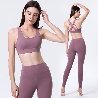 China 2022 Breathable Yoga 2 Piece Set Cross Wear Sports Bra And Full Length High Waisted Stirrup Gaiters Set Women Sports Sets for sale