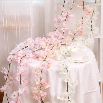 China Cheap Artificial Silk+plastic Cherry Blossom Garland Hanging Silk Flower Vine For Wedding Backdrop Arch Hanging Decor for sale