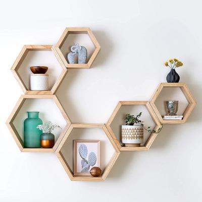 China Stocked Storage rack Decorative wooden hexagonal wall storage honeycomb shelf for sale