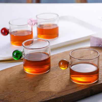 China Wholesale Clear Stored Tea Cup Coffee Mug Water Small Transparent Glass Cup With Ball Shape Handle for sale