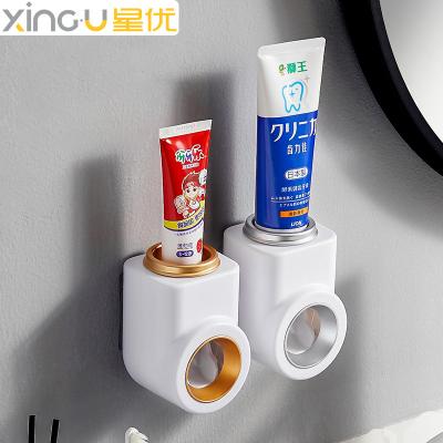 Cina Sustainable New Custom Wall Mounted Plastic Bathroom Hands Free Manual Toothpaste Dispenser in vendita