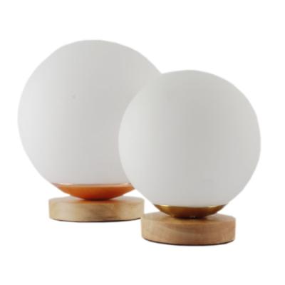 China Easy to Install Indoor Lighting Wooden Base Frosted Glass Spherical Decorative Small Round Glass Table Lamp for sale