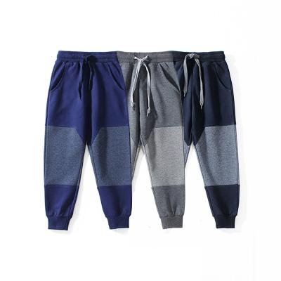 China Anti-pilling customize fashionable new two color stitching men casual pantsChildren slim casual pants for sale