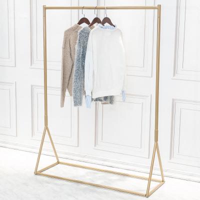 China Latest Design Gold Clothing Rack Display Wall Fashion Show Rack Round Right Angled Tube Floor Display Stand for sale