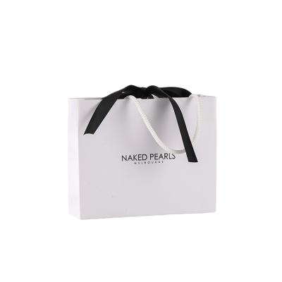 China Reusable Eco-Friendly Recyclable Custom White Paper Package Ribbon White Packaging Bag Luxury Reusable Gift Shopping Bag for sale