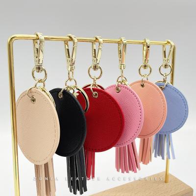 China All Users Leather Circle Keychain PU Vegan Saffiano To Leather With Tassels Custom Logo Metal Hardware for sale