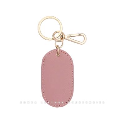 China Faux Saffiano Rose Gold Silver Logo Keychain Oval Shape PU Vegan Leather Material Customized Leather Key Chain for sale