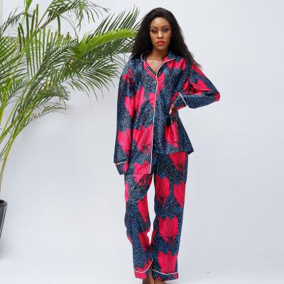 China Latest Design QUICK DRY Wax Print Pajamas Lady Glossy Satin Elastin African Sleepwear Top And Pant 2 PCS Fabric Tops Manufacturer for sale