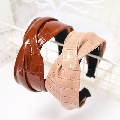 China Korean Fashion Hair Decoration New Solid Color Stripe Faux Leather Headband Women Hair Accessories Pu Leather Trim Cross Headband for sale