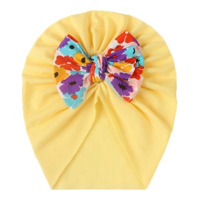 China 2021 autumn and comfortable new winter baby bow hat children's cotton and warm soft printed bow hat turban hat for sale