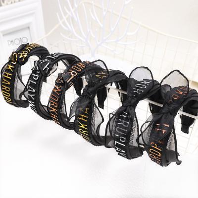 China 2021 retro fashionable elastic black hair band 3D female stereo bronzing press hair letter logo wide side band for sale