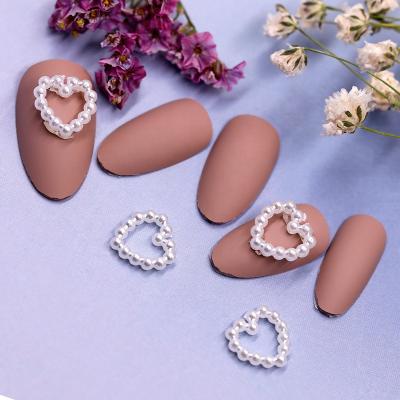 China Newest Arrival 100pcs/bag 3D Heart Shape Pearl Nail Art Decorations DIY Earring Safe Non-toxic And Eco-friendly Hollow Hair Clip for sale