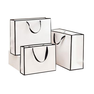 China Recycled Materials High End Custom Black And White Luxury Paper Bag With Logo for sale