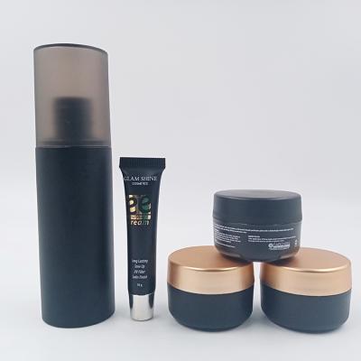 China Wholesale High Quality Black Woody Cosmetic Spray Bottles Cosmetic Face Cream Jars Skin Care PET Plastic Bottle Set Customized for sale