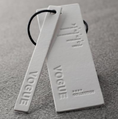 China Viable China Customized Custom Embossed Garment Paper Hang Tags Clothing Brand Tags for sale