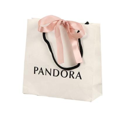 China Recycled Materials Custom Small White Paper Bags With Handles Oil Proof Flat Wedding Cloth With Ribbon Black And White Paper Bag for sale