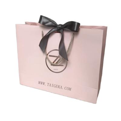 China Recycled Materials Customize Printed Nice Logo Eco-Friendly Shopping Kraft Paper Bags With Ribbon Bow for sale