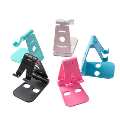 China Adjustable New Plastic Tablet Holder Metal Folding Lazy Phone Holder Charging Base Double Folding Stand for Mobile Phone Tablet PC for sale