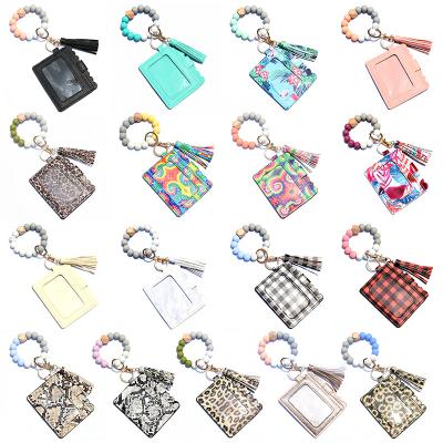 China Leather Women's Wallet Other Key Chains Food Grade Silicone Beads Bracelet Key Chain With Tassel PU Leather Card for sale