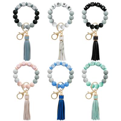 China New Arrival Keychains Love Letter Rubber Silicone Beads Bracelet Tassel Leather Key Ring For Women for sale