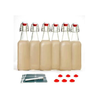 China Beverage Home Brew Bottles Kombucha Juice Bottle Round Swing Top Glass Bottles With Airtight Caps for sale