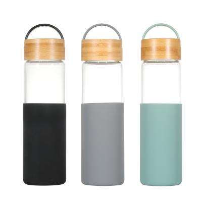 China Outdoor Sustainable 22oz Gym Wide Mouth Borosilicate Glass Water Bottle Insulated With BPA Free Bamboo Lid And Silicone Protective Sleeve for sale