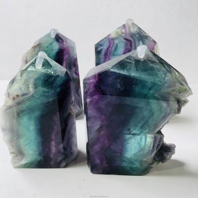 China Wholesale Natural Colored Round Rough Slab Rainbow Healing Point China Fluorite Rough Specimen For Decoration for sale