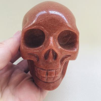 China Europe wholesale hand carved large size natural crystal quartz sand stone gold skulls for sale