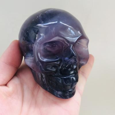 China Europe Wholesale Price Hand Carved Natural Healing Fluorite Quartz Crystal Purple Skulls for sale