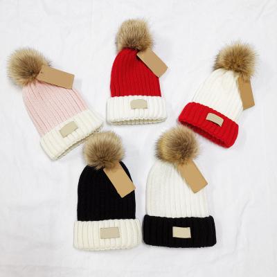 China COMMON Women's Winter Warm Fleece Striped Real Fur Knitted Soft Beanie Hat With Faux Fur Pom Pom for sale