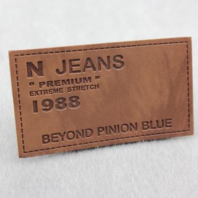 China Workable Logo Design Garment Jeans Label Patch , PU Genuine Custom Embossed Leather Label for sale