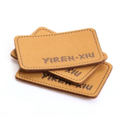 China Durable Embossed Custom PU Material Jeans Leather Labels Patches Garment Accessories for sale